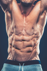 Fototapeta na wymiar Strong Athletic Man Fitness Model Torso showing six pack abs. is