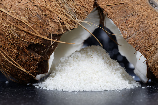 Fresh coconut and coconut desiccated on a stone table