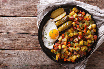 Finnish food pyttipannu: fried potatoes with sausages, eggs and pickled. horizontal top view
