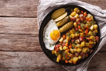 Photo sur Plexiglas Plats de repas Finnish food pyttipannu: fried potatoes with sausages, eggs and pickled. horizontal top view  