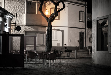 Street cafe in old european town at night
