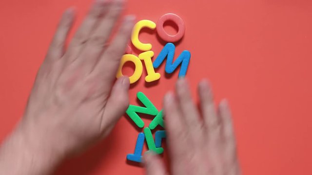 man agitates the letters in the word compettition