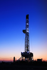 In the evening of oilfield derrick