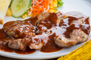 Beef steak with black pepper sauce , salad and French fries on s