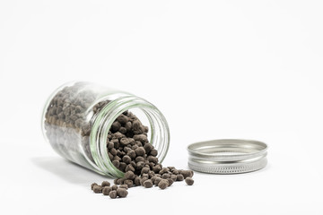 Mineral fertilizers in glass bottle on white background