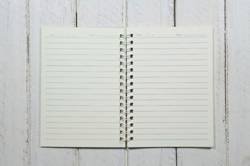 Note book on white wooden table