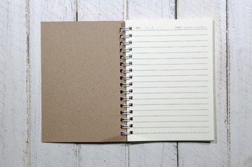 Note book on white wooden table