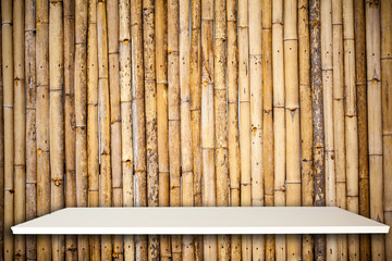 Empty top white shelves and bamboo background