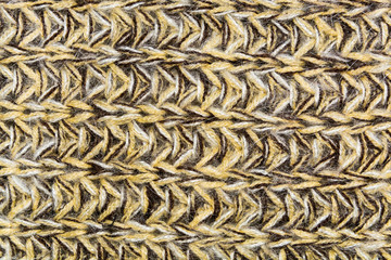 mottled horizontal texture of the wool yellow brown knitted fabric