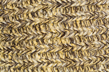 mottled horizontal texture of the wool yellow brown knitted fabric