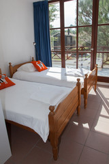 Two single beds in cozy bedroom in a bright house