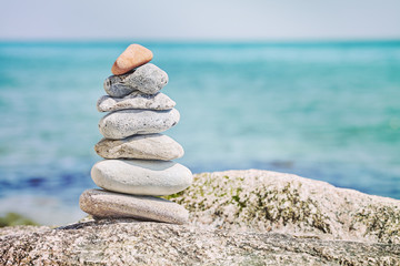 Retro toned stones on beach, harmony concept background.