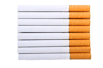 Cigarette with an orange filter lie close to each other isolated on white background