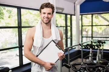 Gym instructor holding clipboard