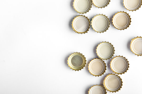 caps of beer on white background