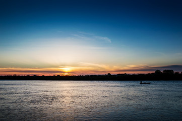Fisherman's boat at beautiful sunset on the river