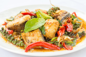 Puff savory fish kang put fresh green peppercorns on dish.