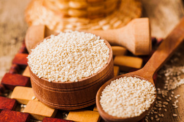 seeds  sesame on wooden spoon