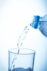 Pouring water from bottle into glass