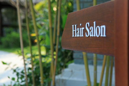 Sign of direction to hair salon in a luxury hotel, resort and spa