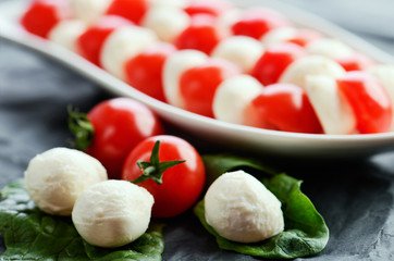 mozzarella cheese balls, ripe cherry tomatoes and caprese salad