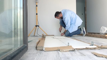 Young man matching pieces of furniture with screwdriver on floor at home
- Powered by Adobe