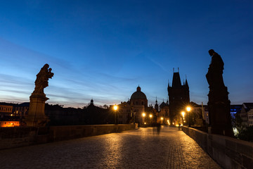 Charles Bridge at sunrise, Prague, Czech Republic. Dramatic statues and medieval towers.