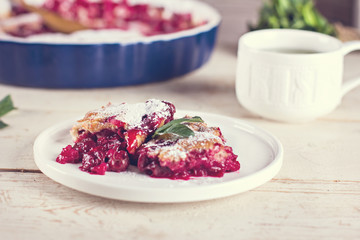 Cherry pie and a cup of tea. Rustic style. Berry pie. Homemade cherry pie with flaky crust, cup of coffee, bowl with cherries