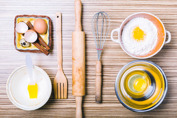 Wooden background with baking ingredients. Top view.