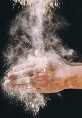 Obraz na płótnie Canvas adult man hands work with flour, dark photo