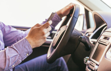 Close-up of a male hand  in a modern car
