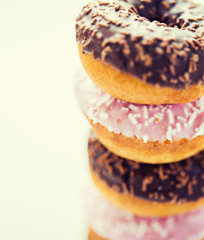 close up of glazed donuts pile over white