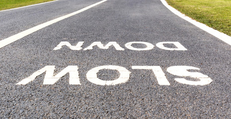 The warning sign to slow down marked on street, safety concept.