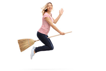 Woman flying on a broom and waving