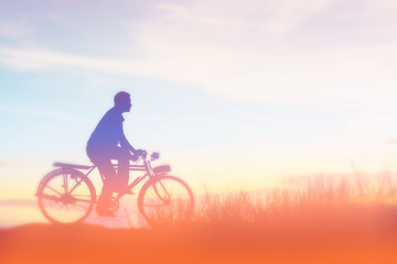 Fototapeta premium silhouette of bicycle with man