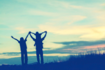 Fototapeta premium silhouette of a happy family and happy time sunset