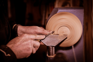 Fototapeta na wymiar Woodturners using a rotating clamp to turn the wood.