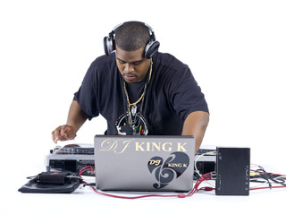 man with laptop playing music