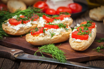 Delicious bruschetta with tomatoes, feta cheese, dill and spice