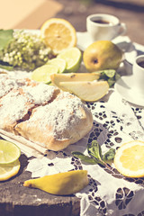 pie, strudel with pear and lemon. Cup of coffee. .Picnic, Breakfast in nature. Food in nature.