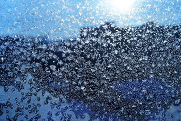 Ice pattern and sunlight on winter glass