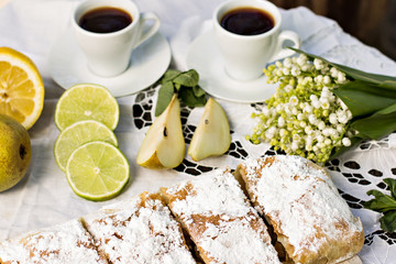 pie, strudel with pear and lemon. Cup of coffee. .Picnic, Breakfast in nature. Food in nature.