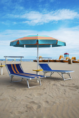 Blue beach chairs and umbrella, Rimini, Italy