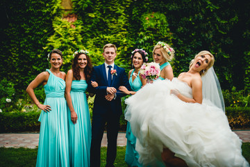 Bridesmaids, groom and his funny wife
