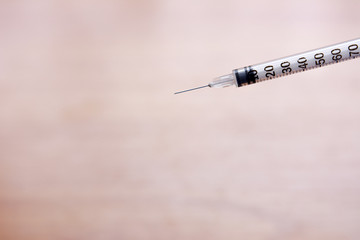 Syringe on wooden table
