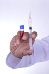 Hand holding syringe on white background