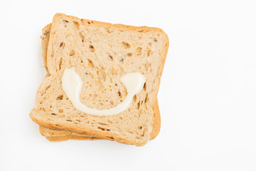 Sweetened condensed milk at Bread on white background