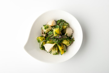 Salad with mushrooms on a plate in the form of drops on a white