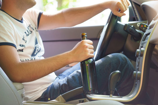 Man drinking beer while driving the car.