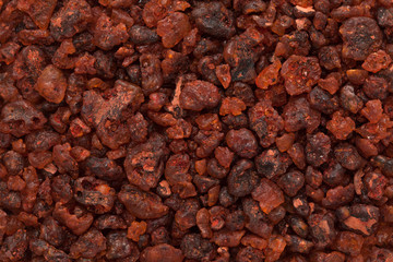 Macro closeup background texture of Organic Natural unwashed Gum Lac Resin produced by Kerria lacca insect. Macro close up background texture. Top view.